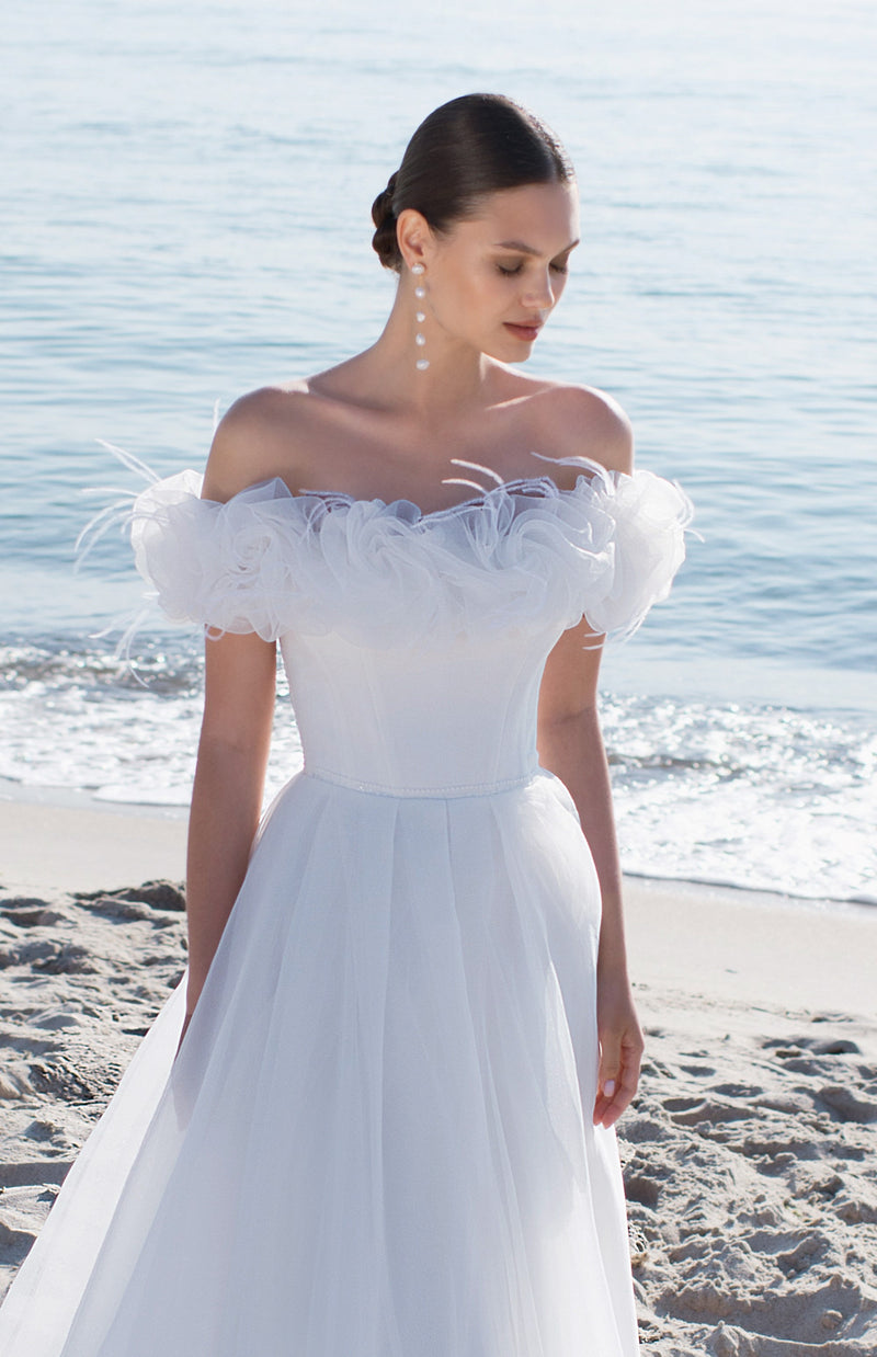 Gorgeous Bride in a fabulous wedding dress walking at the beach