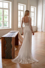 Vestido de novia estilo sirena con mangas largas y lentejuelas