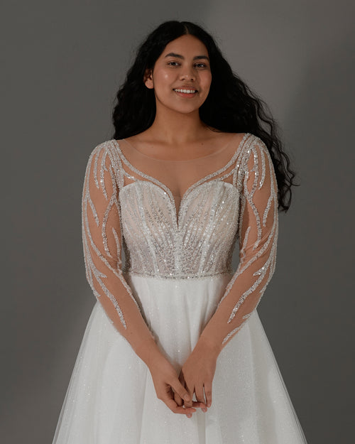 Robe de mariée trapèze à manches longues transparentes et dos corset scintillant 