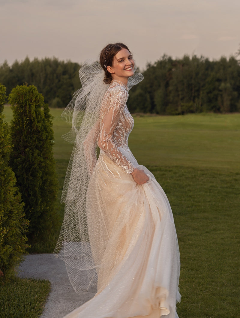 Vestido de novia con purpurina y cuello alto de manga larga