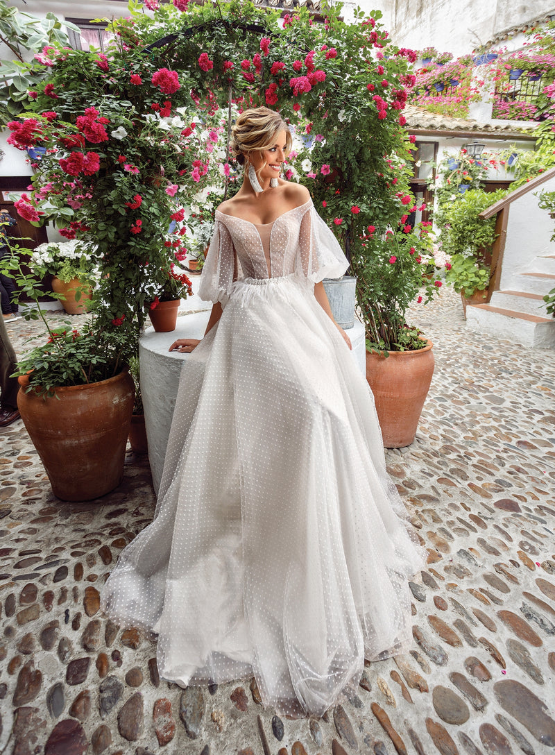 Vestido de novia de lunares con mangas abullonadas y hombros descubiertos